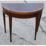 A Regency inlaid mahogany demi-lune fold-over card table, on square tapered supports with spade