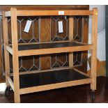 A retro oak and plywood tea trolley, on castored supports