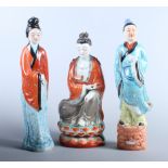 A pair of 20th century Chinese porcelain painted woman, together with a porcelain deity seated on