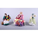 Three Royal Doulton figures, "The Old Balloon Seller" HN1315, "Buttercup" HN2309, and "Flower