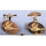 A pair of 9ct gold cufflinks with applied gold pheasant in flight, the eyes naturalistically