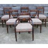 A set of six Regency inlaid mahogany dining chairs with stuffed over seats, on turned supports