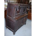 A 17th century oak court cupboard, the upper section enclosed two doors over single door, on bracket