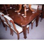 A late 19th century mahogany extending dining table with cut corners and extra leaf, on square taper