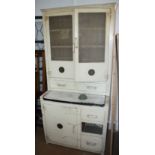 A 1950s white painted kitchen cabinet with pull out work surface, over cupboards and drawers