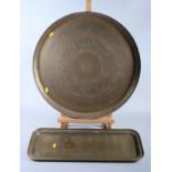 A 19th century brass circular tray, engraved with various figures and characters, 23" dia, with a