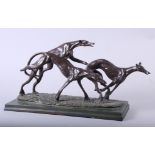 A bronzed Art Deco model of three running and leaping hounds, 15" long