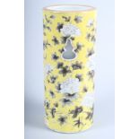 A 19th century Chinese cylindrical pottery vase, decorated with flowers in shades of grey and
