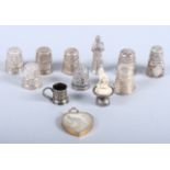 Seven silver thimbles, a white metal filigree thimble, a 9ct gold and carved hardstone heart-