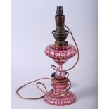 A 19th century ruby cut glass oil lamp (now converted to electricity), 14" high