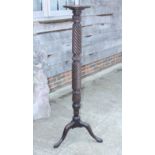 An early 20th century mahogany torchere, on turned central column and three splay supports