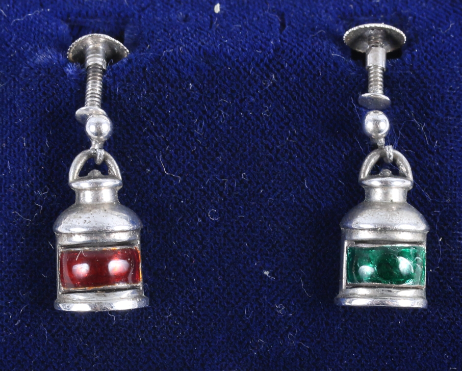 A pair of early 20th century silver and enamel earrings, in the form of port and starboard lamps