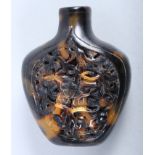 A Chinese tortoiseshell snuff bottle, intricately carved with an articulated butterfly on a