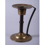 An Arts & Crafts brass and copper candlestick, in the manner of Christopher Dresser, with a reeded