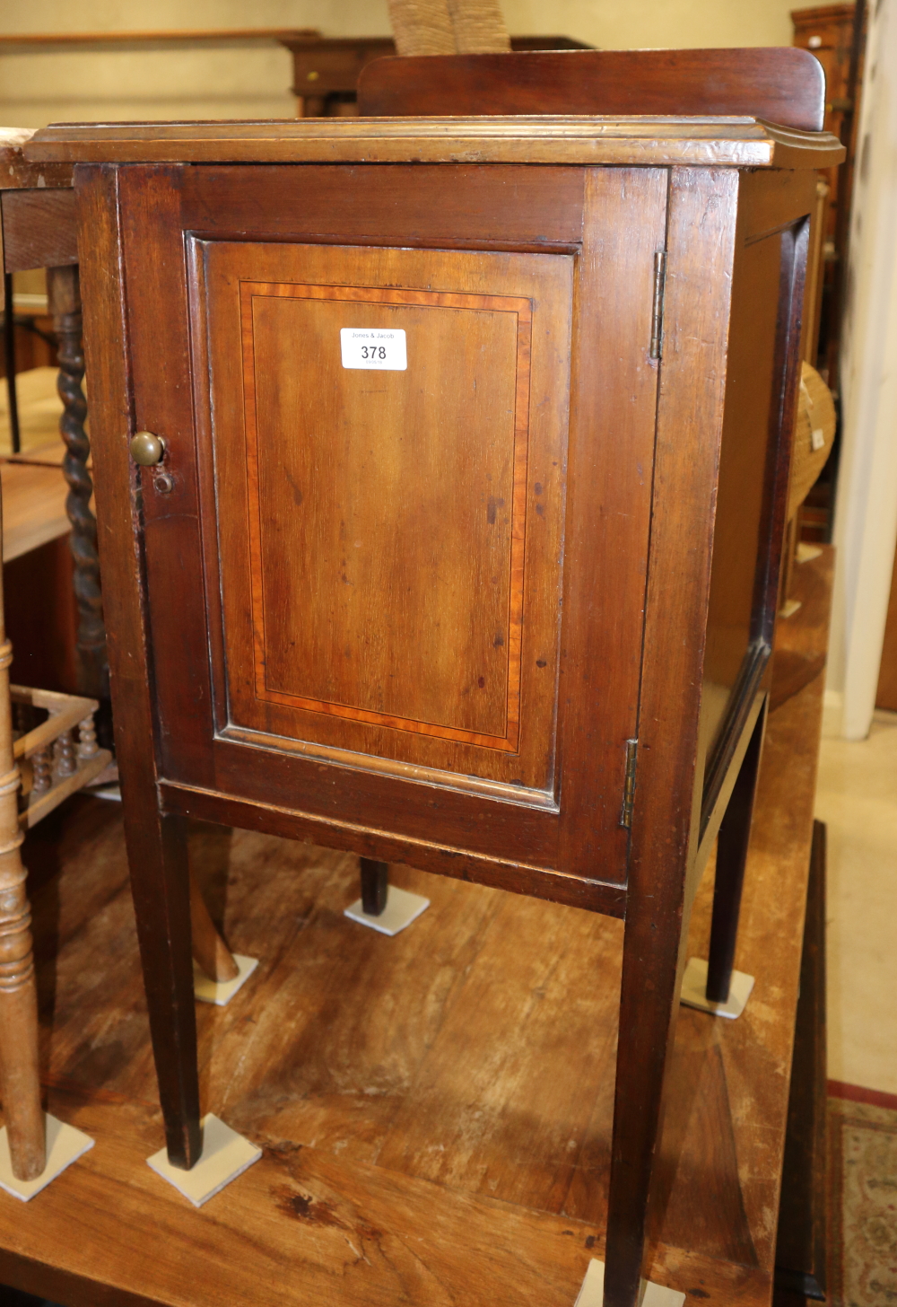 An Edwardian mahogany and satinwood banded bedside cupboard, on square taper supports, 18" wide