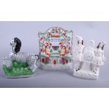A Staffordshire model of a zebra, a Burns and Mary watch group and one other watch holder with