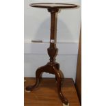 An early 20th century mahogany wine table, on central column with carved knop and tripod splay