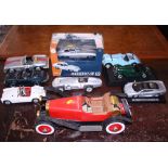 Eight scale models of sports cars and a similar wooden model