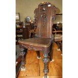 A Victorian oak hall chair, the back carved scrolls
