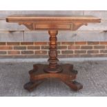 A William IV mahogany fold-over tea table, on carved central column and quadraform base with