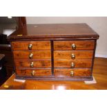 A wooden eight-drawer shop display chest stamped "The Orto boot and shoe laces, 17" wide, and