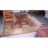 A Persian design wool carpet, decorated palmettes on a rust ground, with beige border stripe, 118" x