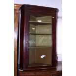 A 19th century mahogany framed wall hung corner cupboard, fitted three shelves enclosed plain