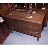 An early 19th century oak drop leaf Sutherland dining table, on square supports