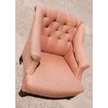 A Victorian low armchair with button back, upholstered in a pink fabric