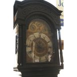 A late 19th century carved oak long case clock with eight-day striking and chiming on bells and