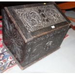 A late Victorian ebonised carved wooden box with sloping hinged lid, front carved lion mask, 26"