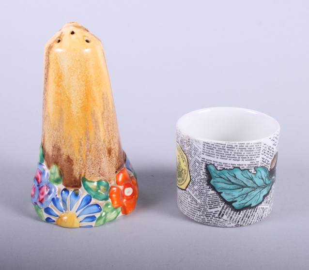 A Clarice Cliff "My Garden" sugar caster (tip restored), 5 1/2" high, and a Fornasetti cache pot,
