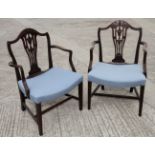 A pair of George III mahogany carver chairs with pierced and carved vase shaped splats and stuffed