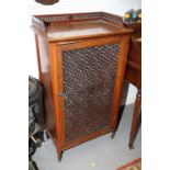 A Victorian walnut pedestal cabinet, with fretted three-quarter gallery and moulded amber glass