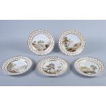 A set of five 19th century French porcelain plates, with landscapes within a gilt painted leaf