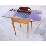 An Edwardian grained as walnut flap top desk with rising stationery compartment, on square taper