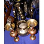 An assortment of brass candlesticks and other brass items