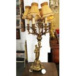 A brass six-branch table lamp with figure supporter, 34" high