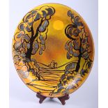 A Poole Aegean pottery oval charger, decorated with Corfe Castle at sunrise, 15 1/2" wide