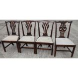 A set of three Chippendale design mahogany dining chairs with pierced splats and drop-in seats, on