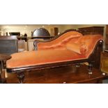 A late Victorian scroll end settee, upholstered in a tangerine velour, 70" long