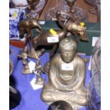 A brass Buddha, a pair of brass stork candlesticks and other ornamental brassware