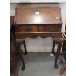 An 18th century grained as walnut bureau, decorated herring-bone stringing with two lower drawers,
