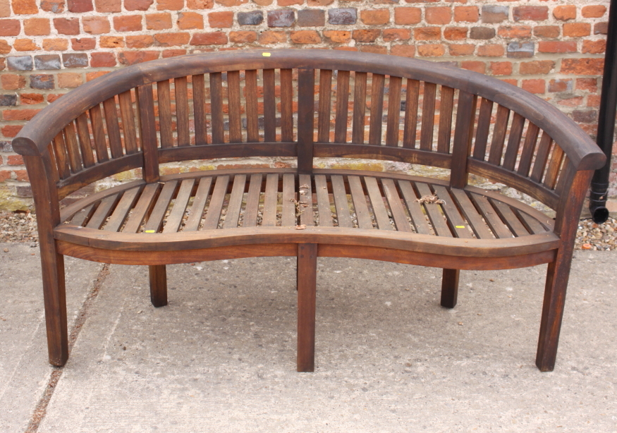 A curved slatted teak garden bench, 62" wide