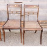 A set of three Regency bar back dining chairs with backs decorated brass bosses, cane seats, on