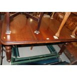 A William IV mahogany extending dining table, with centre leaf and handle, on turned and reeded