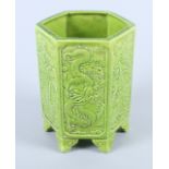 A Chinese green glazed hexagonal pottery brush pot, decorated with phoenix and four claw dragons, on