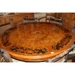 A late 19th century walnut and marquetry work circular tilt top dining table with central panel of