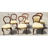 A set of four Victorian carved mahogany balloon back dining chairs, upholstered in a cream fabric,
