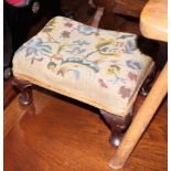 A 19th century mahogany stool with needlepoint seat, on cabriole supports, 12" wide
